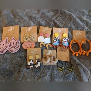 9 pairs of new Plunder earrings. Pink, orange, gold yellow cow print